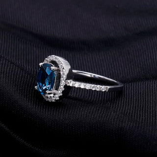 "The Eye of London" 8x6mm Oval Cut Natural London Blue Topaz Halo Ring - Premium Jewelry from Dazzling Delights - Just $109.95! Shop now at Dazzling Delights